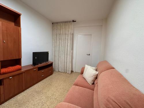 a living room with a couch and a flat screen tv at Apartamento Cervantes in Villena