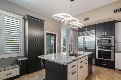 a kitchen with a sink and a stove top oven at Zen Villa in Key West