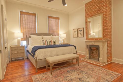a bedroom with a bed and a fireplace at Katie's Cottage in Natchez, Charming Historic Home in Natchez