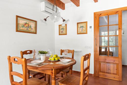 a dining room with a wooden table and chairs at Casa Nova de Biniparrell in Sant Lluis