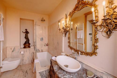 a bathroom with a sink and a mirror at Castello di Casalborgone, Luxury Italian Castle Hotel in Casalborgone