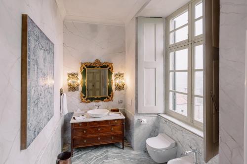 a bathroom with a sink and a mirror at Castello di Casalborgone, Luxury Italian Castle Hotel in Casalborgone