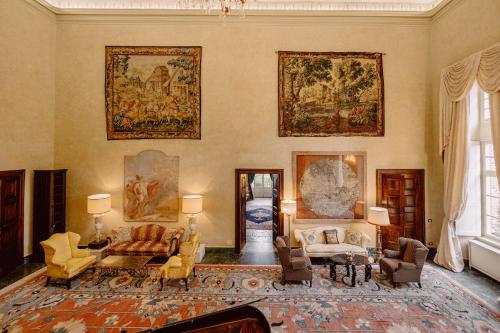 a living room with paintings on the walls at Castello di Casalborgone, Luxury Italian Castle Hotel in Casalborgone