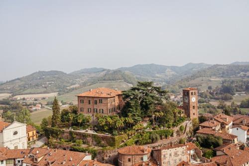 a view of a town with mountains in the background at Castello di Casalborgone, Luxury Italian Castle Hotel in Casalborgone