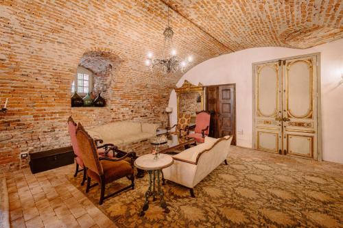 a living room with a brick wall at Castello di Casalborgone, Luxury Italian Castle Hotel in Casalborgone