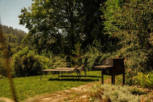 a picnic table and a bench in a field at Ferienwohnung Viktring 4-5 Pers. in Klagenfurt