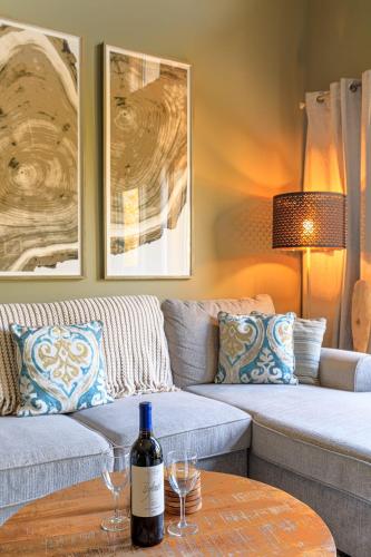 a living room with a couch and a bottle of wine on a table at Summit at The Lodges of Canmore in Canmore