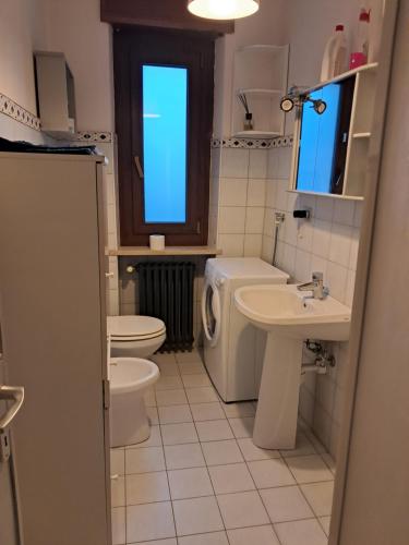 un bagno con un water, un lavandino e uno specchio di Alloggio Grande Joséphine a Oulx