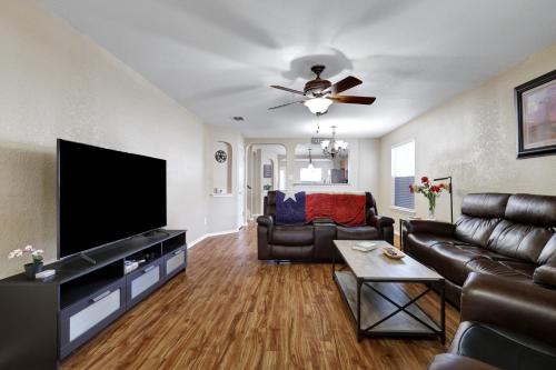 a living room with a couch and a flat screen tv at Texas Star - A Birdy Vacation Rental in San Antonio