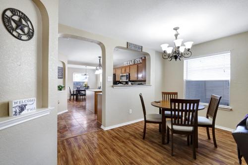 a dining room and kitchen with a table and chairs at Texas Star - A Birdy Vacation Rental in San Antonio