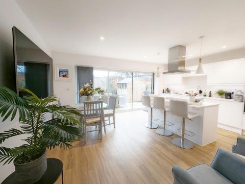 a kitchen and living room with a table and chairs at Charles Street in Petersfield