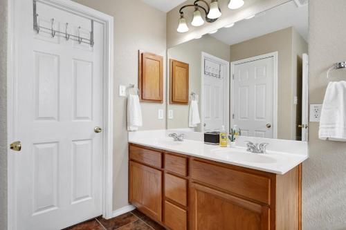 a bathroom with a white sink and a mirror at Texas Star - A Birdy Vacation Rental in San Antonio