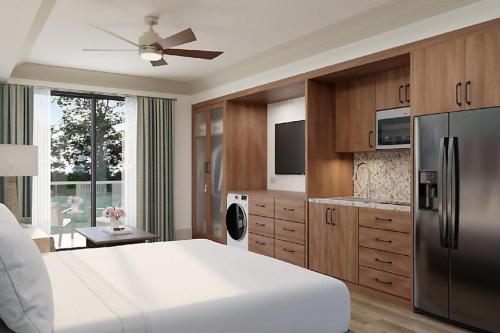 a kitchen with a large white bed and a refrigerator at Hilton Vacation Club Mill Springs Lodge Pigeon Forge in Pigeon Forge