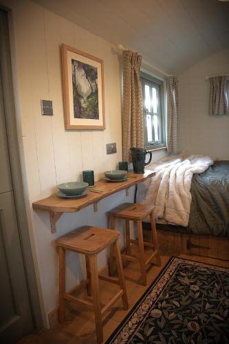 a room with two counters and two stools at Seaside Shepherd's Hut in Mundesley