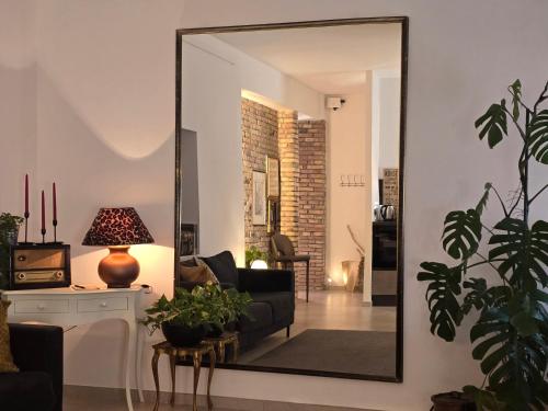 a living room with a mirror on the wall at L'Archetto Apartment in Civitavecchia