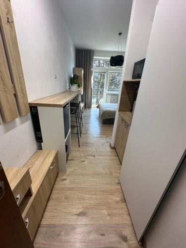 a room with a hallway with a kitchen and a table at Apartmán BB-Centrum1 in Banská Bystrica