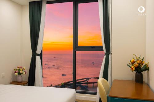 a bedroom with a window with a view of the ocean at Luna Sol Villas - Dedicated Care Until Check Out in Phu Quoc