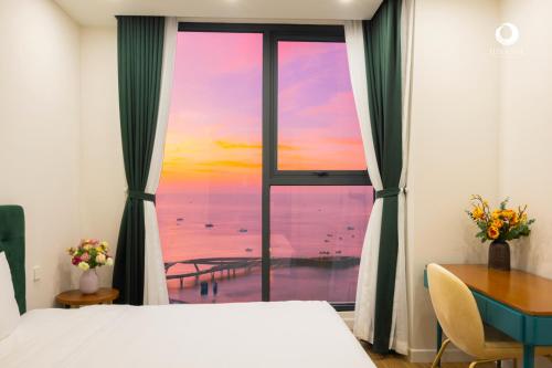 a bedroom with a window with a view of the ocean at Luna Sol Villas - Dedicated Care Until Check Out in Phu Quoc