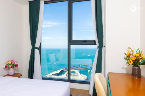 a bedroom with a large window with a boat outside at Luna Sol Villas - Dedicated Care Until Check Out in Phu Quoc