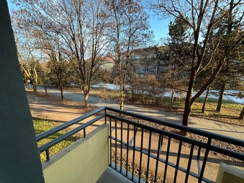 a balcony with a view of a street and trees at Apartmán BB-Centrum1 in Banská Bystrica