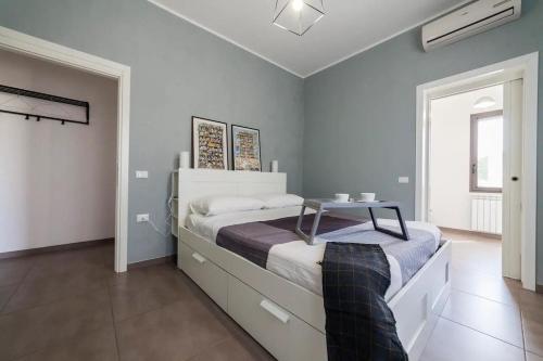 a bedroom with a bed with a table on it at Villa del Sole in Plemmirio