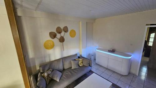 a living room with a couch and a blue light at Villa moderne avec piscine privée à Le François, 70 m² in Le François