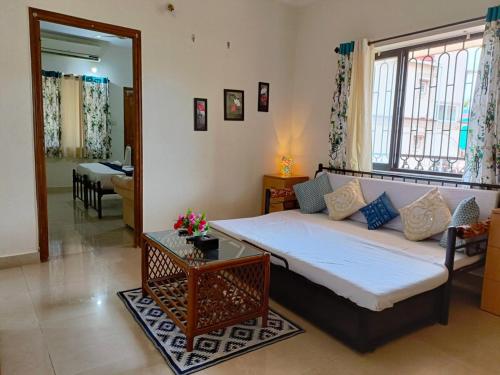 a living room with a bed and a table at 1 BHK near Calangute Beach A1-201 in Calangute