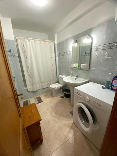 a bathroom with a washing machine and a sink at Atardecer Azul in Puerto Naos