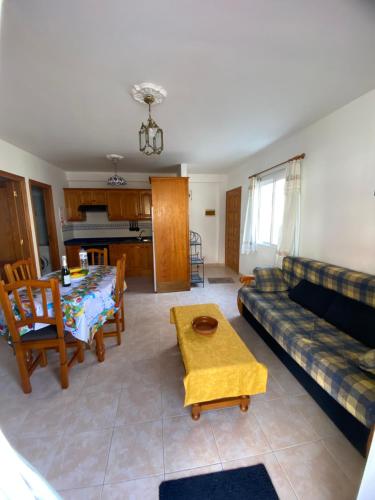 a living room with a couch and a table at Atardecer Azul in Puerto Naos