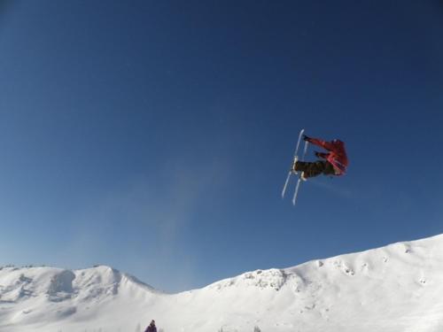 a person jumping in the air on a snowboard at Berggasthof-Ferienbauernhof Habersatt in Altenmarkt im Pongau