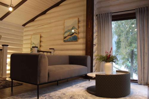 a living room with a couch and a table at Shypit Spa&Resort in Pilipets