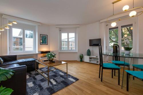 a living room with a couch and a table at KAYA Zurich Apartment SAPPHIRE - Downtown 2BR Deluxe Apt in Zürich