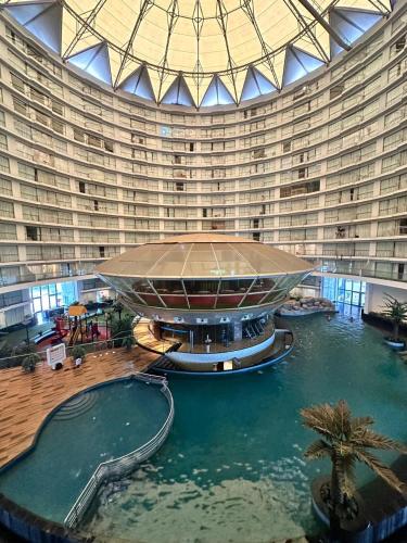 a large building with a swimming pool in front of it at 7 Star homes at Rajhans Belliza in Surat