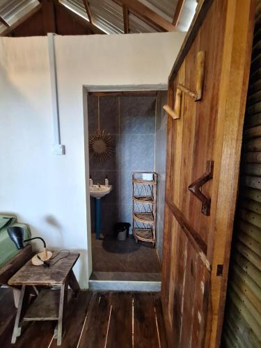 a hallway with a table and a sink in a room at Koalama Cambodia in Koh Rong Sanloem