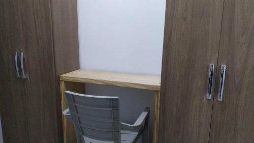a chair sitting under a desk next to a cabinet at Casa Zona de Playa in Palo Verde
