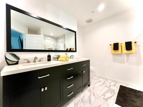 a bathroom with a sink and a large mirror at Gorgeous Home, Great Vibes & Nonstop Fun! in Desert Hot Springs