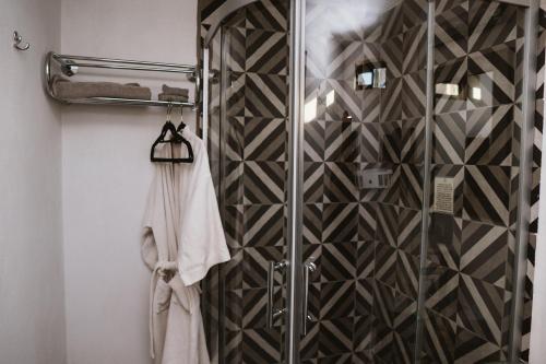 a shower with a glass door in a bathroom at La Finca de Vane in Valle de Guadalupe