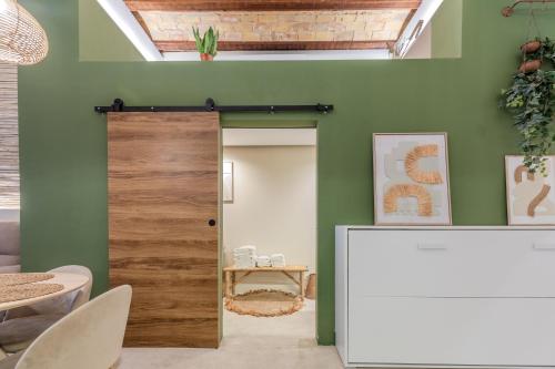 a door in a room with a green wall at GREEN&FRESH Apartament in Valencia