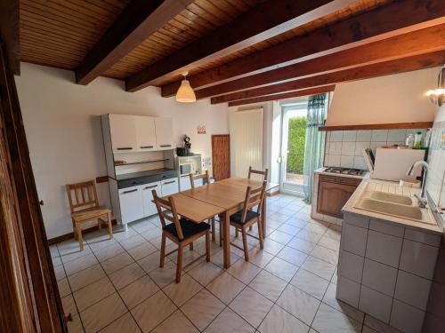 a kitchen and dining room with a table and chairs at Gîte familial avec terrasse et espace enfants à Faymont - FR-1-583-370 in Faymont