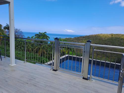 a balcony with a view of the ocean at Domaine Choco Vanille in Deshaies