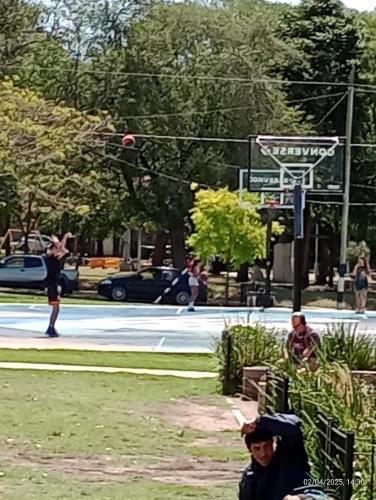 a group of people playing basketball in a park at house city in Mar del Plata