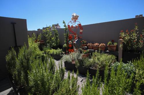 a statue of a woman standing in a garden with plants at Anselmo Buenos Aires, Curio Collection by Hilton in Buenos Aires