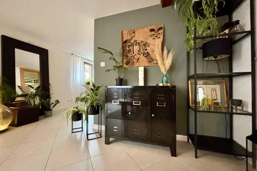 a room with a cabinet with plants on the wall at Beautiful apartment of 67 m2 near Strasbourg in Bischheim