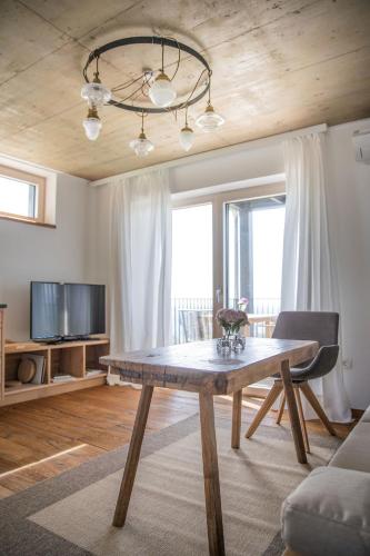 a living room with a wooden table and a couch at Winzarei Ciringa Stampfer in Svečina