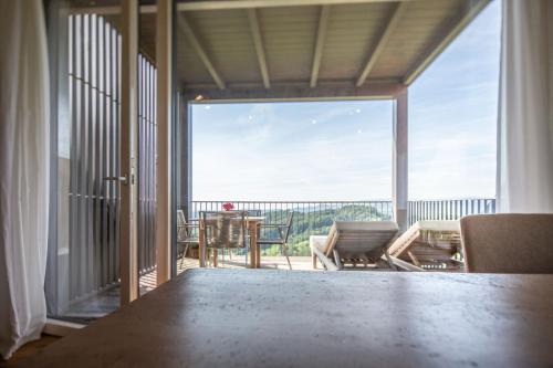 a room with a view of a balcony with a table and chairs at Winzarei Ciringa Stampfer in Svečina
