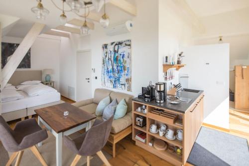 a living room with a couch and a table and a bed at Winzarei Ciringa Stampfer in Svečina