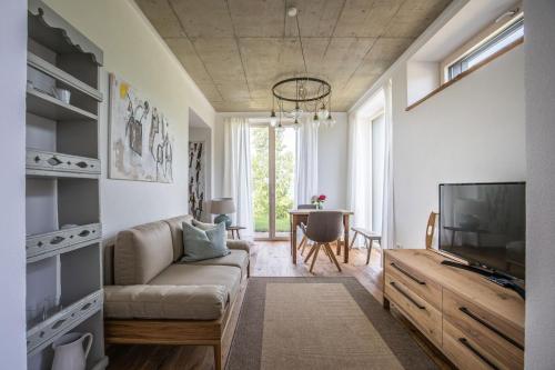 a living room with a couch and a tv at Winzarei Ciringa Stampfer in Svečina