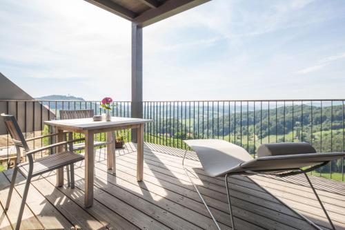 a balcony with a table and chairs and a view at Winzarei Ciringa Stampfer in Svečina
