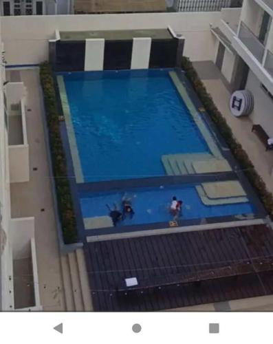 an overhead view of a large swimming pool at Condo 604 Baguio retreat with pool and gym in Baguio