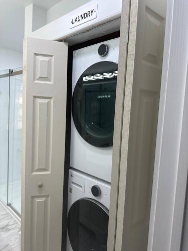 a washer and dryer in a room next to a door at Azalea in Charlottesville